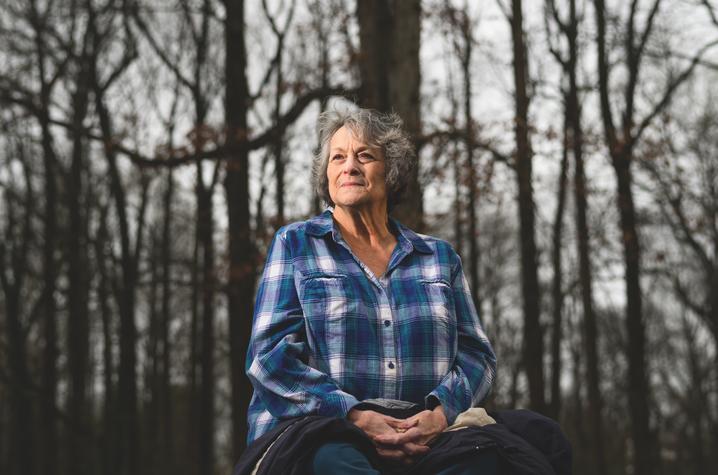 Debra Kantosky sitting the woods