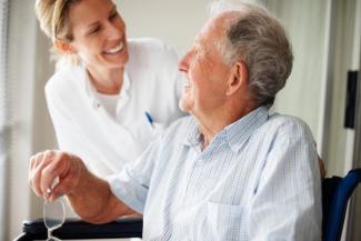 smiling older man with caretaker