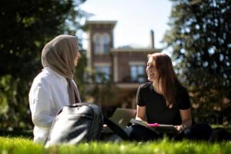 Students talking in grass