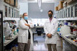 Photo of UK researchers Patrick Sullivan and Brad Hubbard in lab
