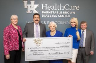 Photo of Barnstable Brown family presenting check