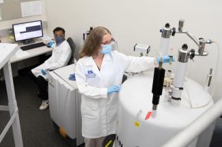 Photo of Sylvie Garneau-Tsodikova, a professor in UK College of Pharmacy's Department of Pharmaceutical Sciences and principal investigator on the grant, working with Vivek Subramanian, director of the UK PharmNMR Center.