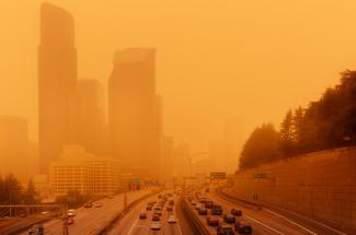 Photo of city skyline and wildfire smoke