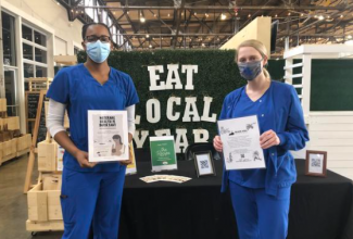 Students from the College of Nursing set up a booth at Lexington's Julietta Market to help Black Soil address health disparities in Lexington's communities of color. (photo courtesy of Black Soil)