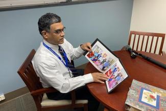 Markey radiation oncologist Dr. Mahesh Kudrimoti shows photos of his family in India. The COVID-19 crisis in the country has taken six of his family members.