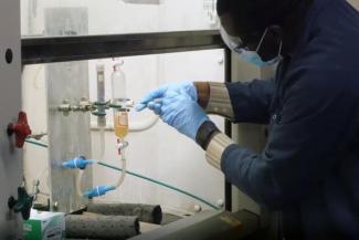 Reynolds Frimpong, senior research engineer at CAER, works on a carbon dioxide capture experiment.