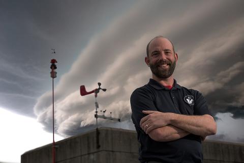 photo of Josh Durkee standing in front of a stormy sky