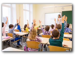 children raising hands in a classroom