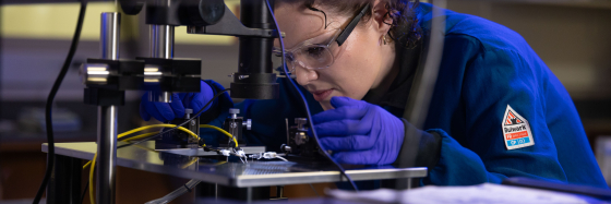 Zan Paterson working at a machine in a lab